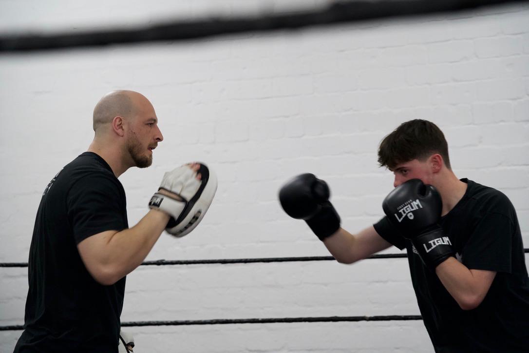 Boxing pad work in the ring
